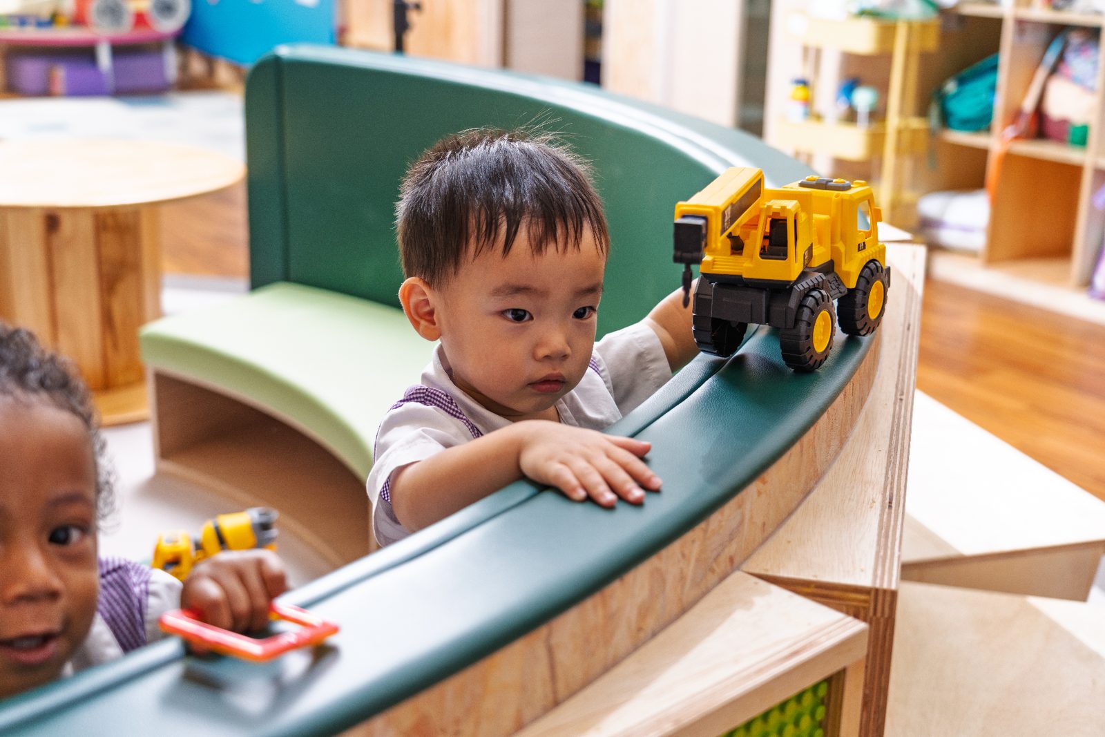Child playing with toy truck at Mulberry